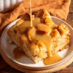 Drizzling bourbon sauce on a slice of bread pudding.