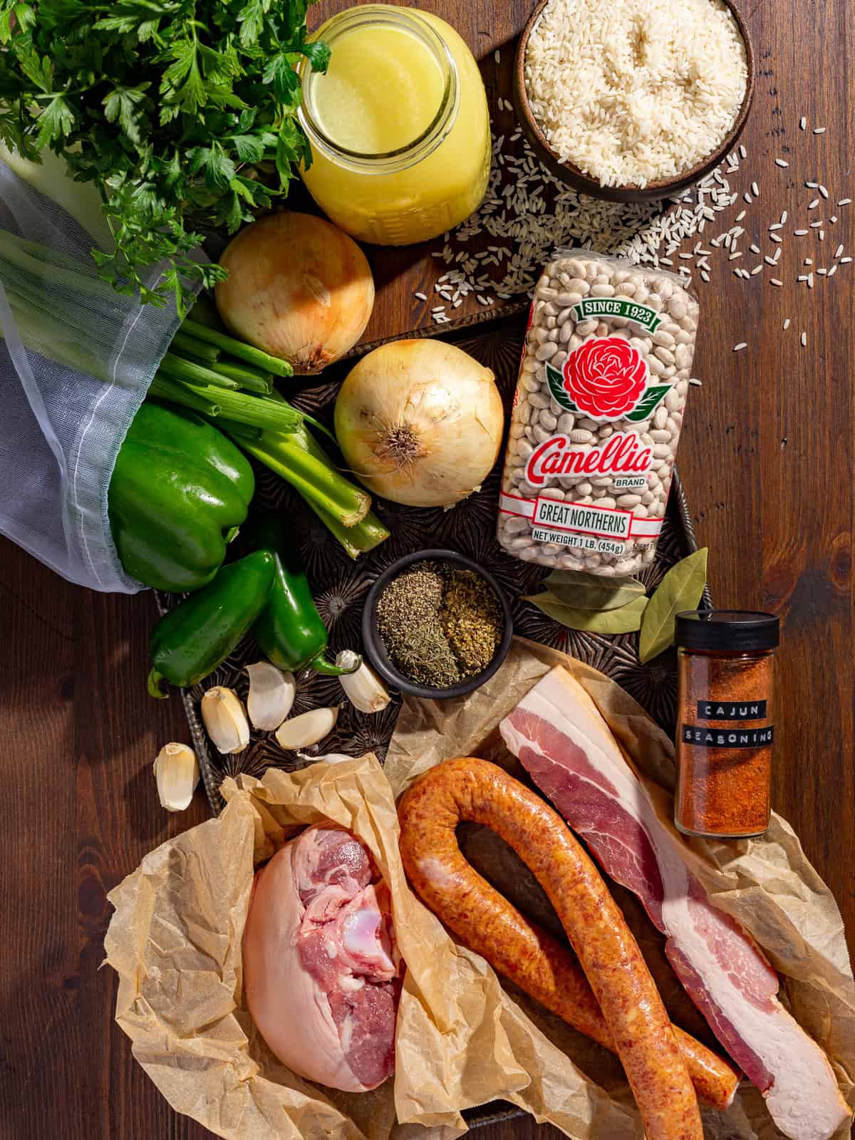 Ingredients needed to make white beans on a table.